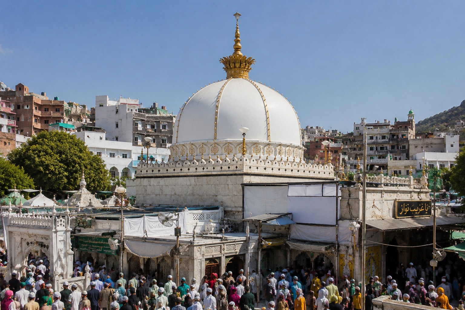 Twilight at Ajmer Sharif Dargah, the marble shrine of Khwaja Moinuddin Chishti, with devotees raising hands in prayer